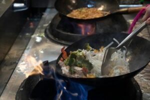 From Scratch to Perfection: How Pho Restaurants Make Their Broth 1 (cooking pho in a wok)