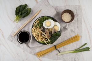 Vietnamese Instant Ramen: A Quick Taste of Authentic Flavor 2 Close-up of Vietnamese instant ramen with broth, noodles, and aromatic ingredients on rustic table