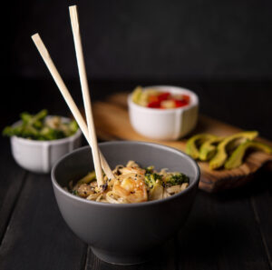 What Is Pho Noodles Made Of? The Secret Behind Vietnam’s Signature Dish 3 Rice noodles being added to hot pho broth during the cooking process.