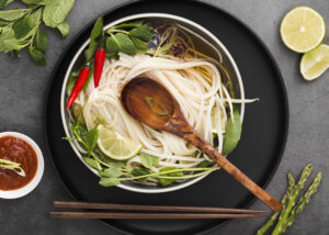 Is Pho High in Cholesterol? Here’s What You Should Know 2 Close-up of pho ingredients including rice noodles, herbs and lean protein illustrating a low-cholesterol dish.