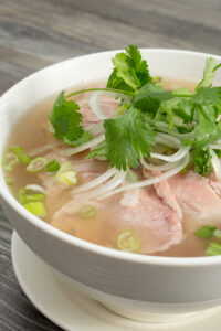 Flat Rice Noodles for Pho: Why Shape and Texture Matter 1 Bowl of pho with fresh herbs.