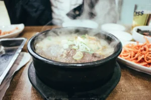 What Ingredients Give Pho Its Comforting Qualities? The Secret Behind the Flavor 2 Steaming bowl of pho soup served at restaurant table